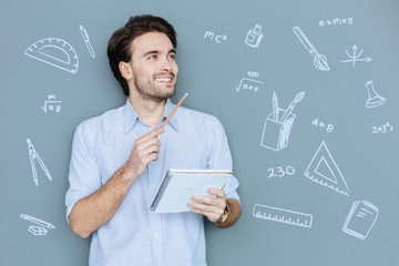 Easy mathematical problem. Cheerful enthusiastic young man being at the Math lesson and feeling...