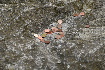Coins on a rock