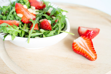 Fruit salad from arugula and strawberries.