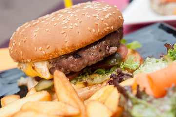 closeup of hamburger and french fries at restaurant