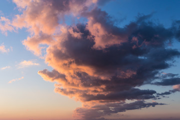 Dramatic sunset sky with orange colored clouds.