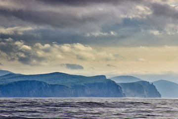 rocky seashore and cloudy sky.