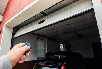 Garage door PVC. Hand use remote controller for closing and opening garage door.