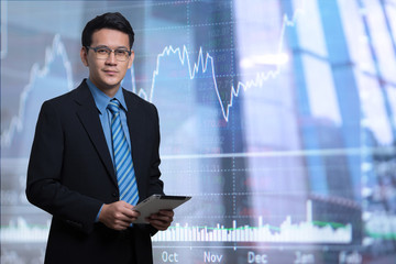 Portrait young businessmen using tablet on financial background
