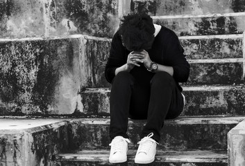 Young Asian desperate in life. Concept of despair in life in the dark tone.