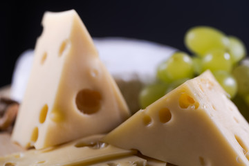 Different kinds of cheese on wooden background