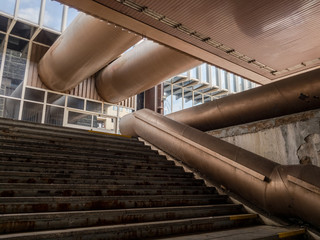 Architecture made in high-tech and brutalist architectural style. Starircase and pipes, pipeline,...