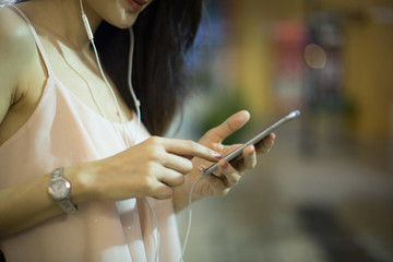 Beautiful young woman's hand using smart phone on the street