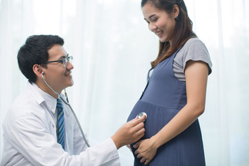 Fototapeta premium Young preganant woman expecting a baby doctor visit