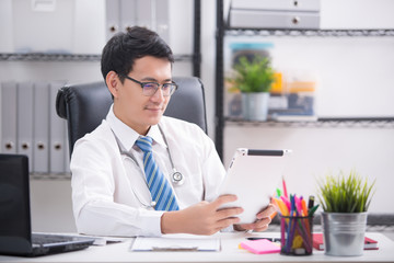 doctor working with tablet in office