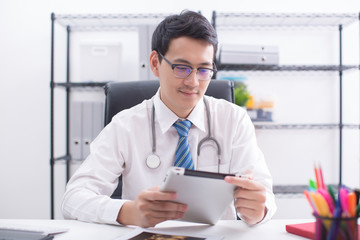 doctor working with tablet in office