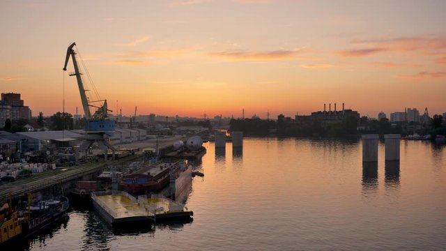 Aerial view over industrial factory near river with air atmosphere and river water, ecological, sunset