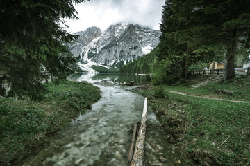 Fototapeta na wymiar Wild stream in Pragser Wildsee or Braies Lake in Italy.