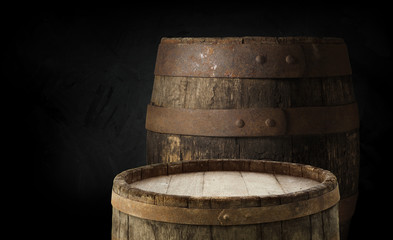 Beer barrel with beer glass on table on wooden background