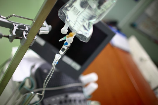 View Of Doctor's Office With Equipment And Iv Drip Bag On The Steel Pole