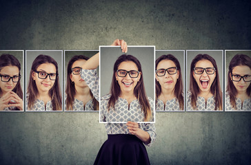 Girl holds and changing her face portraits with different expressions