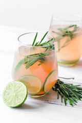 healthy morning with fresh drink, lime and rosemary on white tab