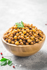 Vegan healthy snack,spicy roasted chickpeas in bowl. Selective focus, space for text.