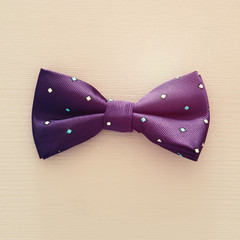 Top view of fabric male bowtie over blue background.