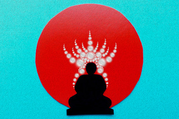 The shadow of a man in meditation in Nirvana, glowing circles of prana in the sun