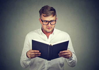 Amazed man reading book