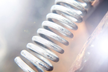 Suspension spring macro blurred background sunlight