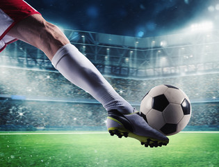 Soccer player with soccerball at the stadium ready for the match