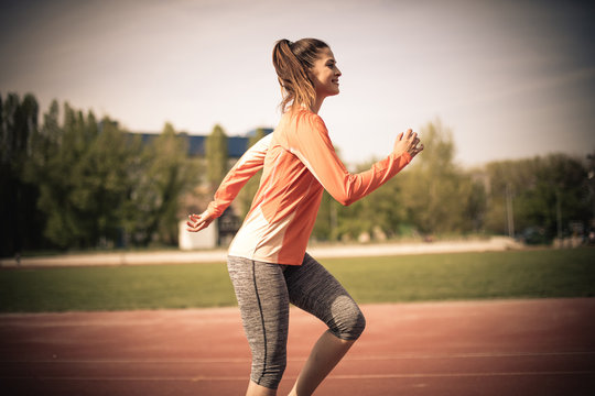 Healthy lifestyle. Woman running. Close up image.