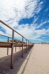 Wooden footbridge at the sand beach in Portugal