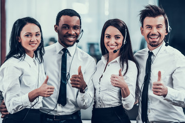 Happy multiracial call center team shows thumbs up - obrazy, fototapety, plakaty