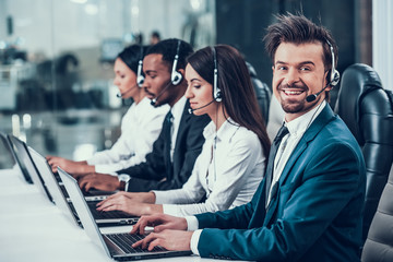 Multicultural young happy employees in call center