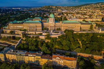 Budapest, Hungary - Aerial view of the famous Buda Castle Royal palace and Varkert bazaar at sunrise with Buda side and Buda Hills at background