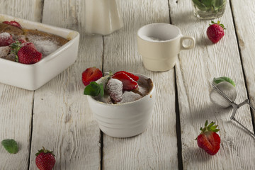 Cottage cheese casserole in white dish decorated with strawberries