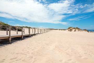 Wooden footbridge at the sand beach in Portugal