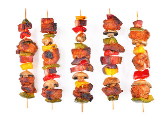Roasted pork skewers with bacon, diced red, yellow, green bell pepper, champignons and onion...
