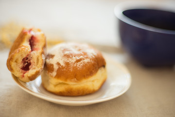 Naklejka na ściany i meble donuts in a saucer on a table with a mug of tea