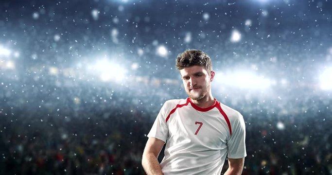 Happy soccer player on a football stadium