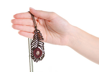 Bijouterie chain with a feather in a hand on a white background isolation