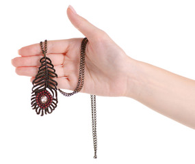 Bijouterie chain with a feather in a hand on a white background isolation