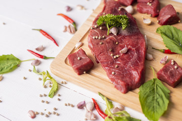 Raw beef on white wood background
