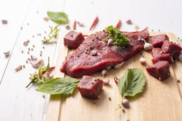 Raw beef on white wood background