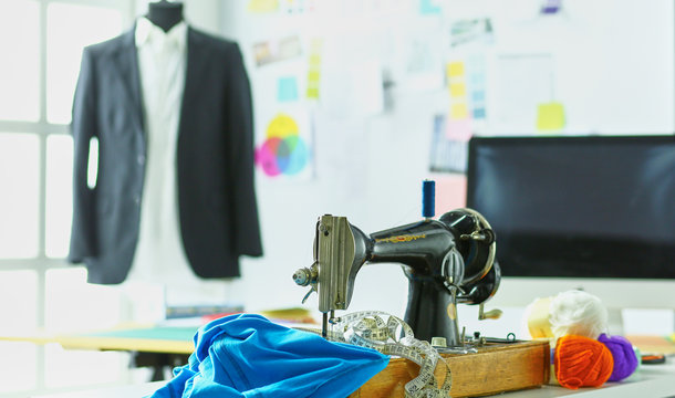 Retro sewing machine on designer clothes desktop