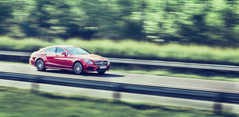 Obraz na płótnie Canvas Car driving fast on highway motion blur