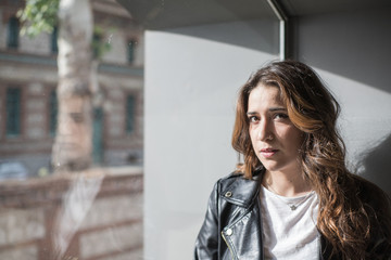 Fototapeta premium portrait of beautiful woman in front of a window