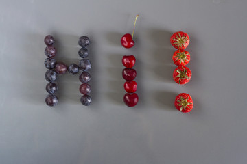 Juicy healthy summer berries of strawberries, cherries and grapes in the form of the word 