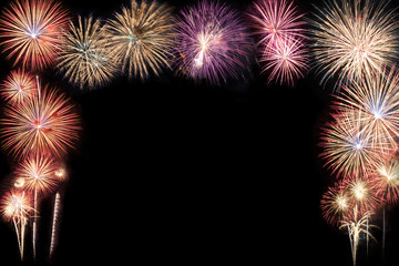 Abstract beautiful colorful fireworks display for celebration on black background with free space for text. New year holiday concept.