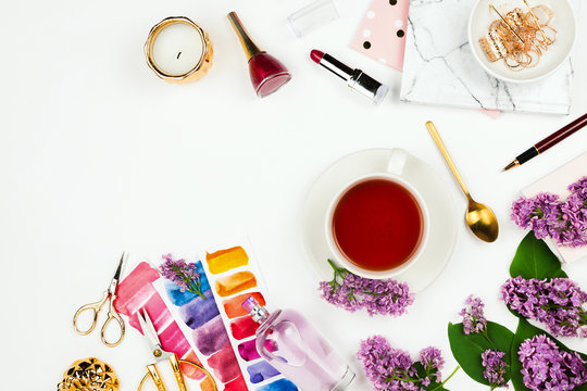 Lifestyle and business mockup flatlay with cup of tea, lilac, notebook, perfume and other accessories on white with copyspace