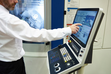 Man controls CNC milling machines