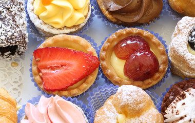 many pastries with custard and fresh fruit