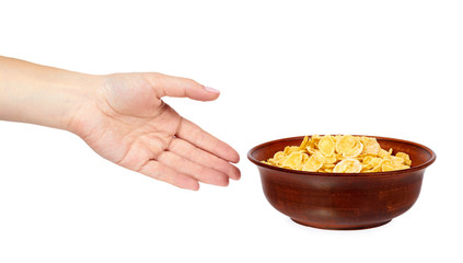 bowl of corn flakes with hand isolated on white background